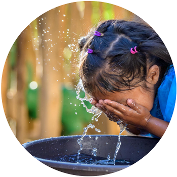 Girl washing face with clean water.
